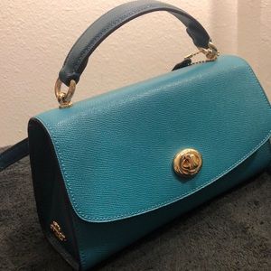 COACH two toned crossbody bag with gold accents.